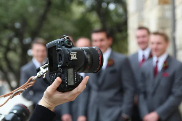 Group of men and a camera in focus.